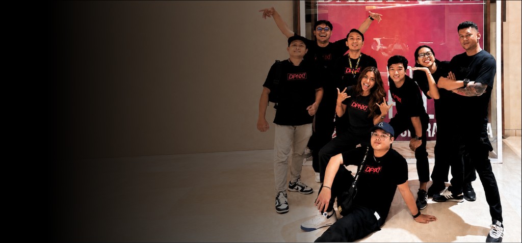 DPNX! Event Solution team posing together in front of a Daily News lightbox display